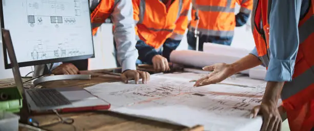 CAD Drafting Overview - A detailed blueprint on a desk with drafting tools, symbolizing precision and innovation in construction projects.